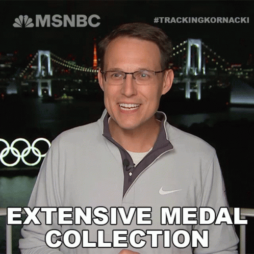 A Man Wearing Glasses And A Nike Jacket Is Smiling In Front Of A Bridge And The Words " Extensive Medal Collection " GIF