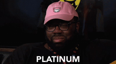 A Man Wearing Glasses And A Pink Hat With The Word Platinum On It GIF