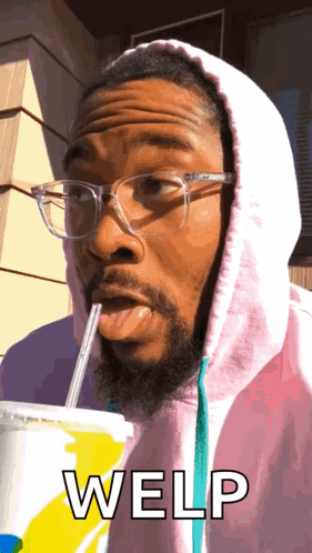 A Man Wearing Glasses And A Pink Hoodie Is Drinking Through A Straw And The Word Welp Is Written Below Him GIF