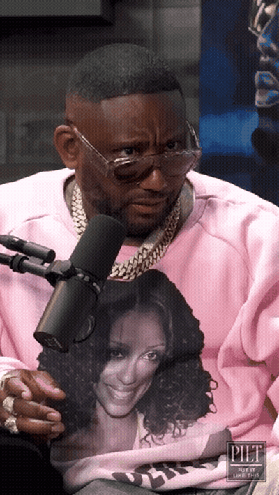 A Man Wearing Glasses And A Pink Sweatshirt With A Picture Of A Woman On It GIF