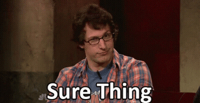A Man Wearing Glasses And A Plaid Shirt Is Sitting In Front Of A Sign That Says Sure Thing . GIF