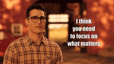 A Man Wearing Glasses And A Plaid Shirt Says " I Think You Need To Focus On What Matters " In Front Of A Building GIF