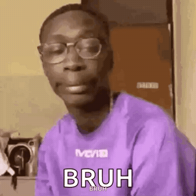A Man Wearing Glasses And A Purple Shirt Is Making A Face . GIF