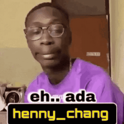 A Man Wearing Glasses And A Purple Shirt Is Making A Funny Face And Saying Eh Ada Henny Chang . GIF