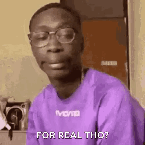 A Man Wearing Glasses And A Purple Shirt Is Making A Funny Face And Saying `` For Real Tho '' . GIF