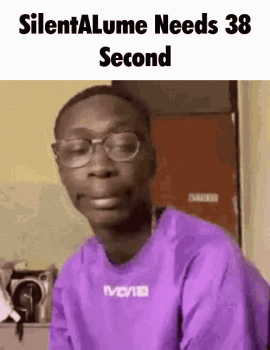 A Man Wearing Glasses And A Purple Shirt Is Making A Funny Face GIF