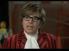 A Man Wearing Glasses And A Red Cape Is Saying Funny . GIF