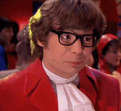 A Man Wearing Glasses And A Red Jacket Looks Serious GIF