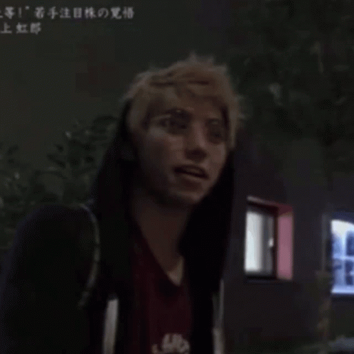 A Man Wearing Glasses And A Red Shirt Has Chinese Writing On The Bottom Right GIF