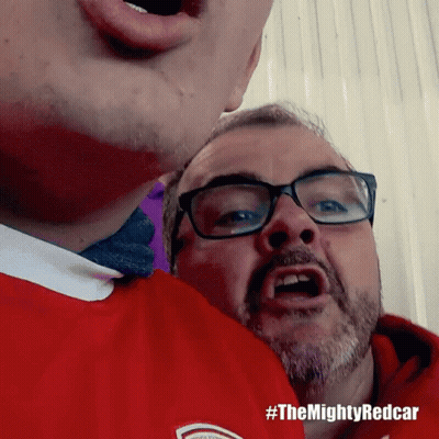 A Man Wearing Glasses And A Red Shirt Has #Themightyredcar Written On The Bottom GIF