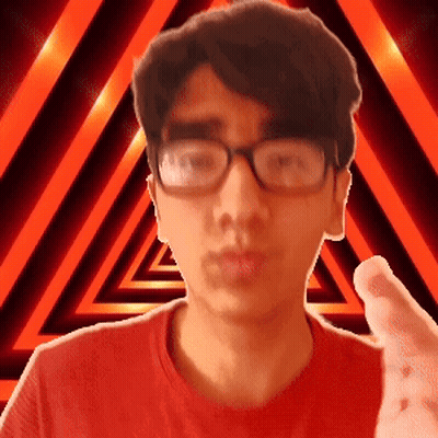 A Man Wearing Glasses And A Red Shirt Is Pointing GIF