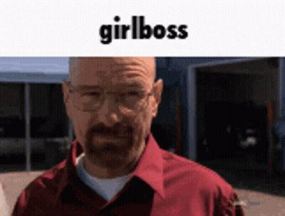 A Man Wearing Glasses And A Red Shirt Is Standing In Front Of A Garage With The Words Girlboss Written Above Him GIF