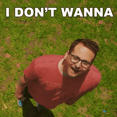 A Man Wearing Glasses And A Red Shirt Is Standing In The Grass With The Words " I Don 'T Wanna " Above Him GIF