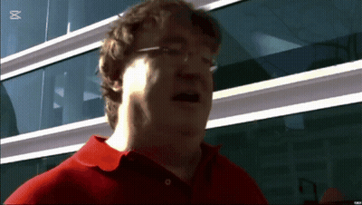 A Man Wearing Glasses And A Red Shirt Stands In Front Of A Building With The Letter M On The Bottom Right GIF