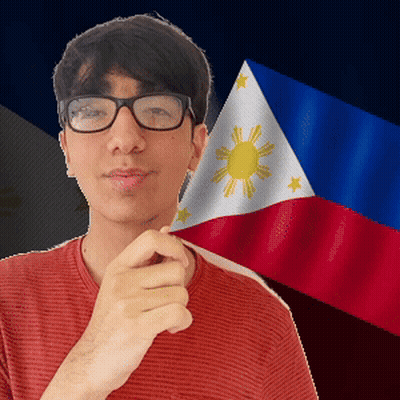 A Man Wearing Glasses And A Red Shirt Stands In Front Of A Flag GIF