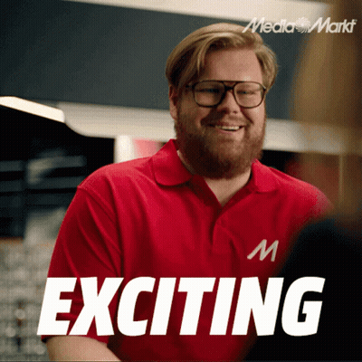 A Man Wearing Glasses And A Red Shirt With Exciting Written On It GIF