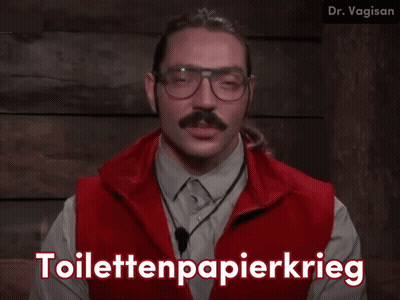 A Man Wearing Glasses And A Red Vest Says Toilettenpapierkrieg In White Letters GIF