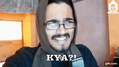A Man Wearing Glasses And A Scarf On His Head Is Smiling And Says Kya ? GIF