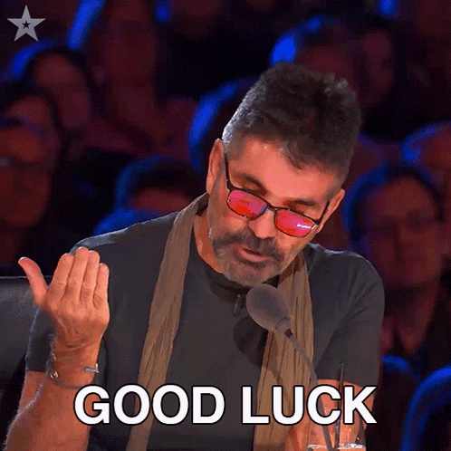 A Man Wearing Glasses And A Scarf Says " Good Luck " GIF