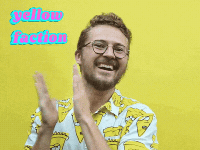 A Man Wearing Glasses And A Shirt That Says Yellow Faction Is Clapping GIF