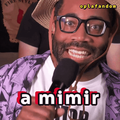 A Man Wearing Glasses And A Straw Hat Is Holding A Microphone And Says A Mimir GIF