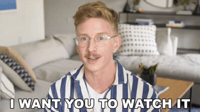 A Man Wearing Glasses And A Striped Shirt Says I Want You To Watch It GIF