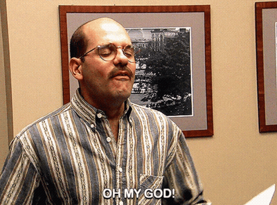 A Man Wearing Glasses And A Striped Shirt Says " Oh My God " GIF