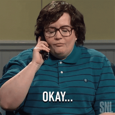 A Man Wearing Glasses And A Striped Shirt Says Okay On The Phone GIF