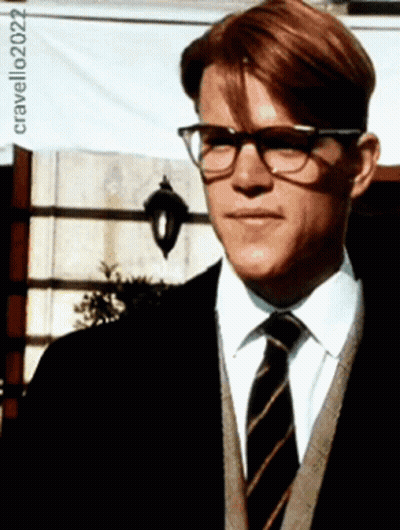 A Man Wearing Glasses And A Striped Tie Is Standing In Front Of A Sign That Says Cravello202022 GIF