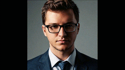 A Man Wearing Glasses And A Suit And Tie GIF