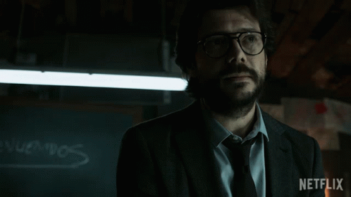 A Man Wearing Glasses And A Suit Has A Netflix Logo On The Bottom Right GIF