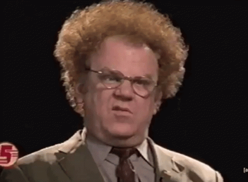 A Man Wearing Glasses And A Suit Has The Number 5 On His Chest GIF