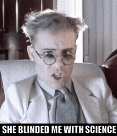 A Man Wearing Glasses And A Suit Has The Words She Blinded Me With Science Below Him GIF