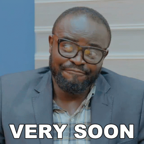 A Man Wearing Glasses And A Suit Has The Words Very Soon Written On His Face GIF