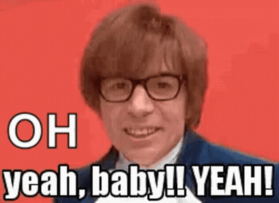A Man Wearing Glasses And A Suit Is Smiling And Says `` Oh Yeah , Baby ! Yeah ! '' GIF