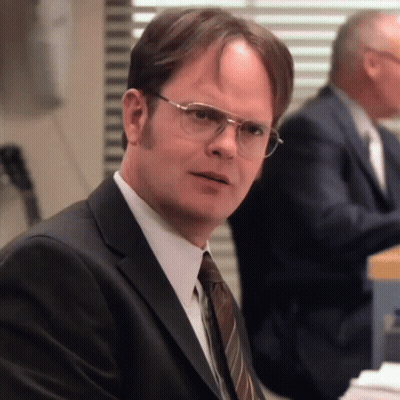 A Man Wearing Glasses And A Suit Looks Serious GIF