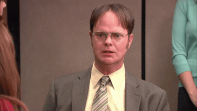 A Man Wearing Glasses And A Suit Looks Serious GIF