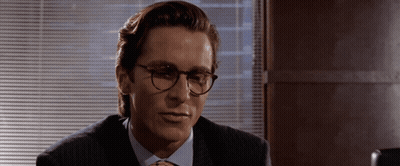A Man Wearing Glasses And A Suit Looks To The Side GIF