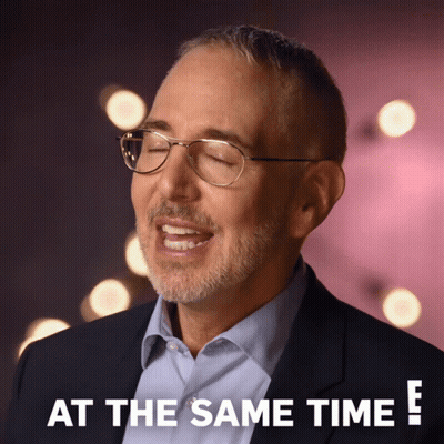 A Man Wearing Glasses And A Suit Says " At The Same Time " GIF