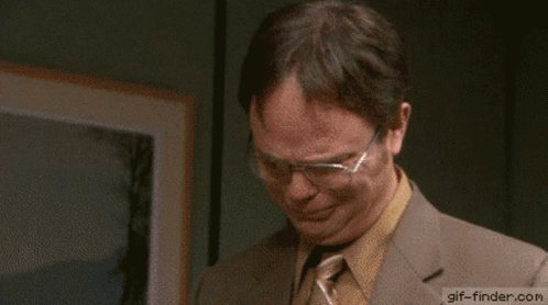 A Man Wearing Glasses And A Suit Says Thank You GIF
