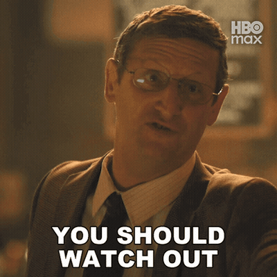 A Man Wearing Glasses And A Suit Says You Should Watch Out GIF