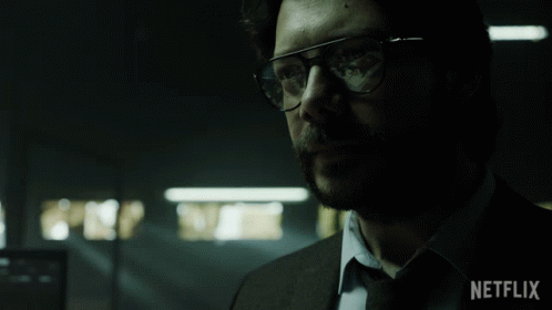 A Man Wearing Glasses And A Suit With Netflix Written On The Bottom Right GIF
