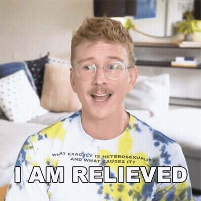 A Man Wearing Glasses And A Tie Dye Shirt Is Saying I Am Relieved GIF