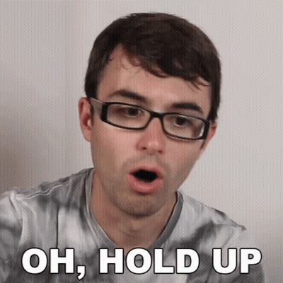 A Man Wearing Glasses And A Tie Dye Shirt Is Saying Oh Hold Up GIF