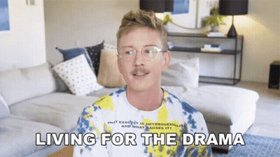 A Man Wearing Glasses And A Tie Dye Shirt Is Talking About Living For The Drama GIF