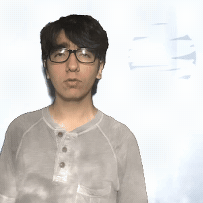 A Man Wearing Glasses And A Tie Dye Shirt Stands In Front Of A White Background GIF