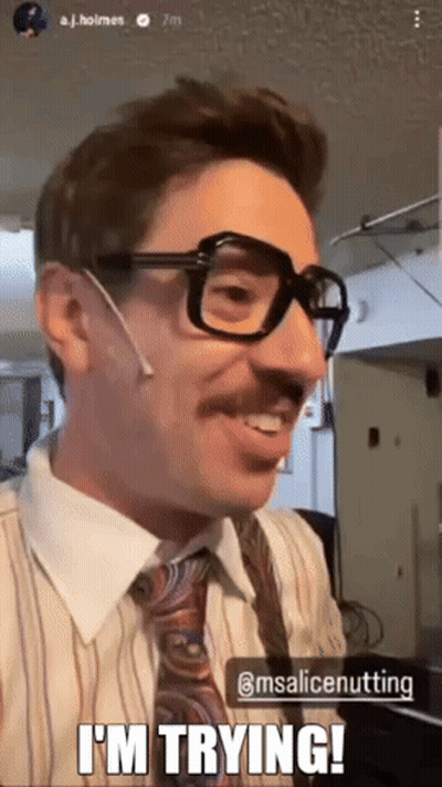 A Man Wearing Glasses And A Tie Is Smiling And Says I 'M Trying GIF