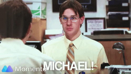 A Man Wearing Glasses And A Tie Is Talking To Another Man With The Words " Michael " On The Bottom Right GIF