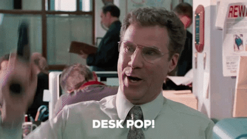 A Man Wearing Glasses And A Tie Says Desk Pop GIF