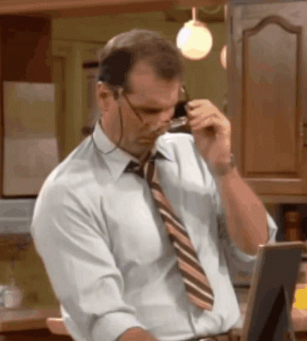 Man With Glasses And Tie Talking On Phone GIF